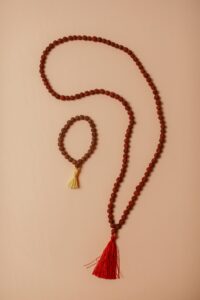 Beautiful arrangement of rudraksha beads on a beige background, showcasing traditional craftsmanship.